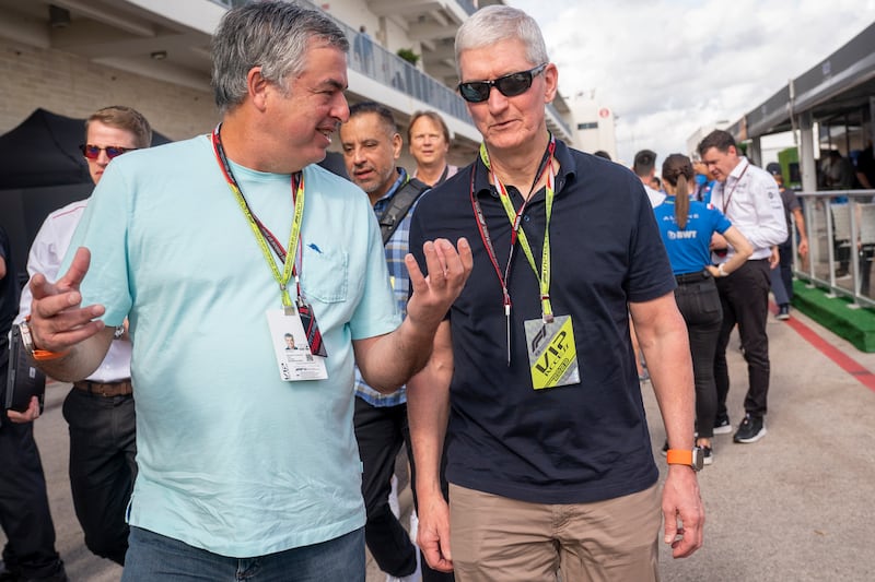 Apple CEO  Tim Cook, right, in the paddock prior to the Formula One Grand Prix of the US. EPA