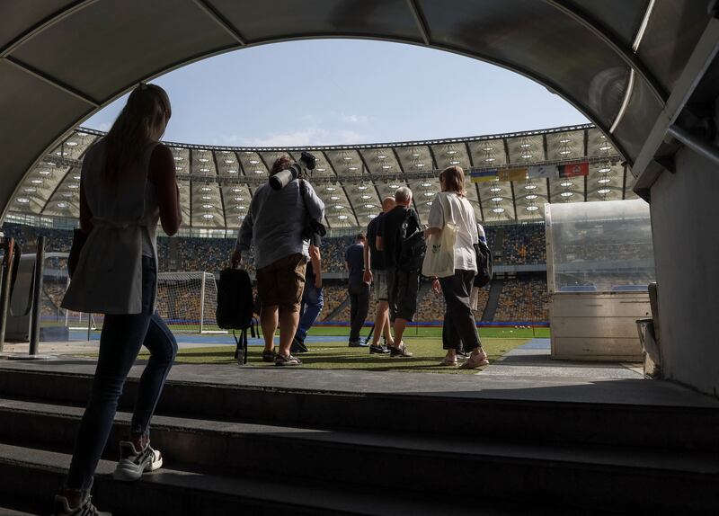 Journalists leave a shelter after an air strike alarm at the NSC Olimpiyskiy stadium during a training session. Reuters
