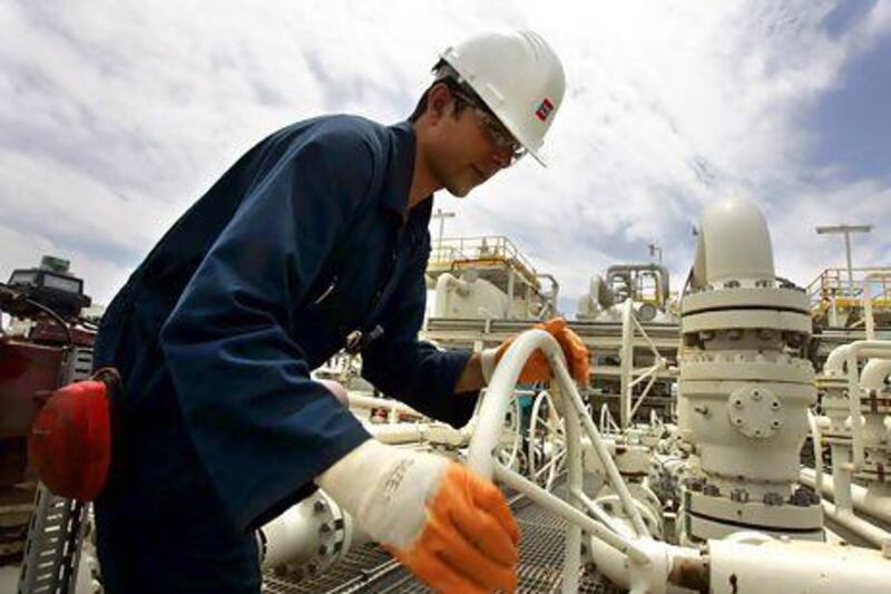 A worker adjusts a valve of an oil pipe in Tawke oil field. Azad Lashkari / Reuters