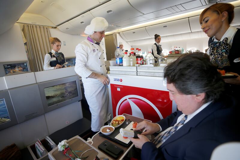 Staff serve a business class meal on a Turkish Airlines flight. Turkey's flag carrier came fourth in the survey. Getty Images