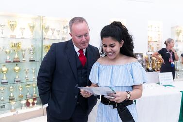 Ebani Dhawan receives her A-Level results, with the prinicipal Simon O’Connor, at Jumeirah College. Reem Mohammed / The National