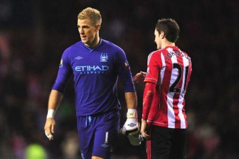 Manchester City goalkeeper Joe Hart is consoled by Adam Johnson.
