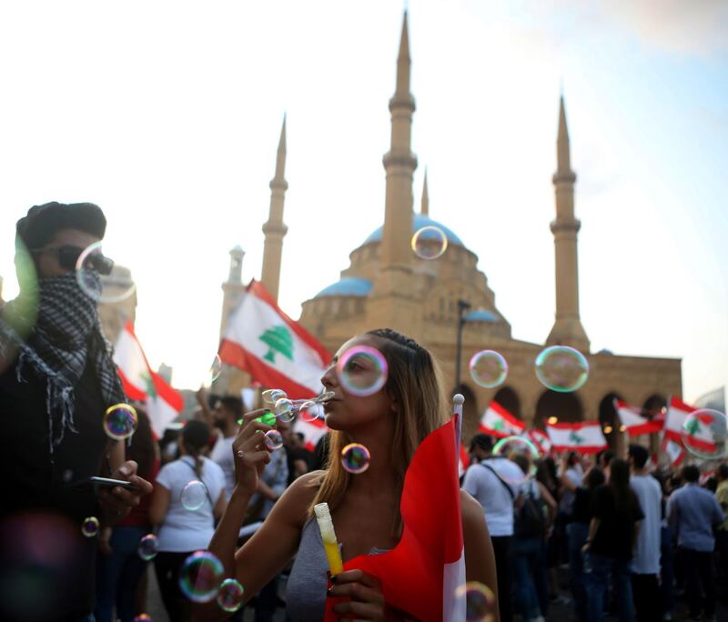 Demonstrators blow soap bubbles outside the Mohammad al-Amin mosque. AFP