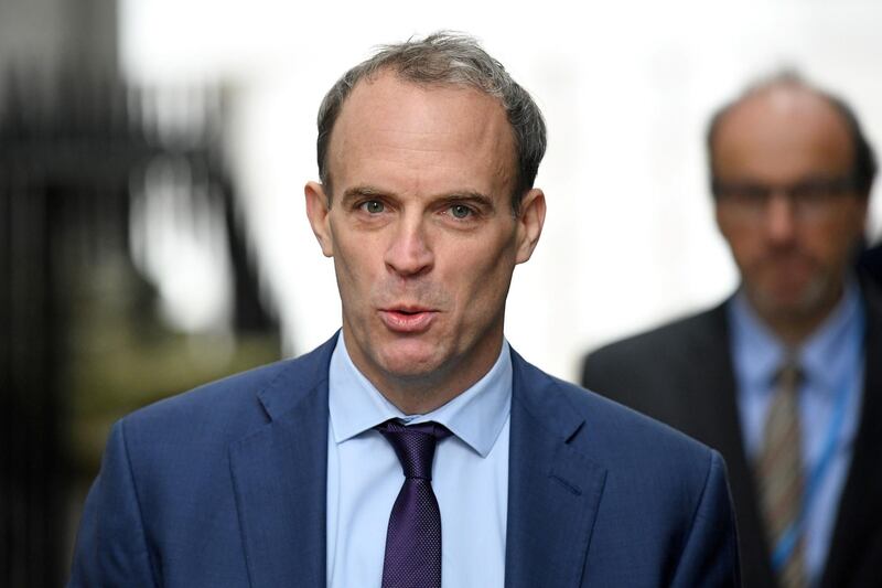 Britain's Foreign Secretary Dominic Raab reacts as he arrives in Downing Street in central London on October 6, 2020. British Prime Minister Boris Johnson will seek to banish the coronavirus gloom with a vision of a prosperous future fuelled by floating windmills when he addresses his Conservative party's annual conference Tuesday. In a speech closing the four-day digital event, he will highlight an election pledge to quadruple the power generated by offshore wind from 10 to 40 gigawatts this decade, saying it would support 60,000 new jobs. / AFP / Daniel LEAL-OLIVAS
