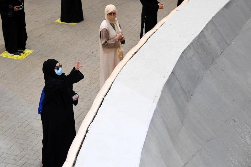 Women cast their pebbles at the devil. Saudi Press Agency / Reuters