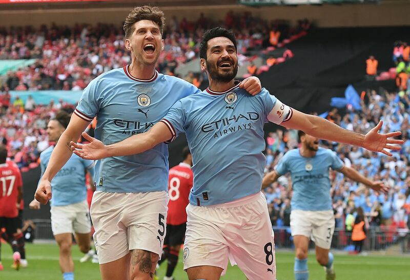 Manchester City's Ilkay Gundogan celebrates with teammate John Stones after scoring the second goal against Manchester United in the FA Cup final at Wembley on Saturday, June 3, 2023. EPA