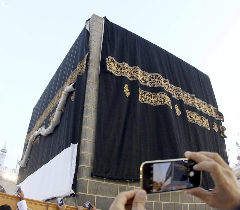 The Kaaba's kiswah is replaced. Saudi Press Agency