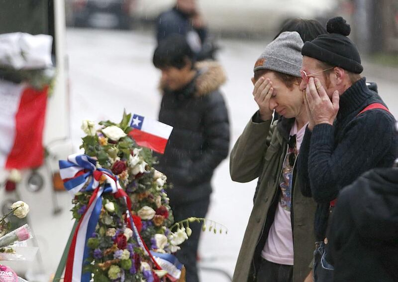 Jesse Hughes, right, and Julian Dorio, members of Eagles of Death Metal band, mourn in front of the Bataclan concert hall to pay tribute to the shooting victims in Paris, France on December 8, 2015.  Reuters