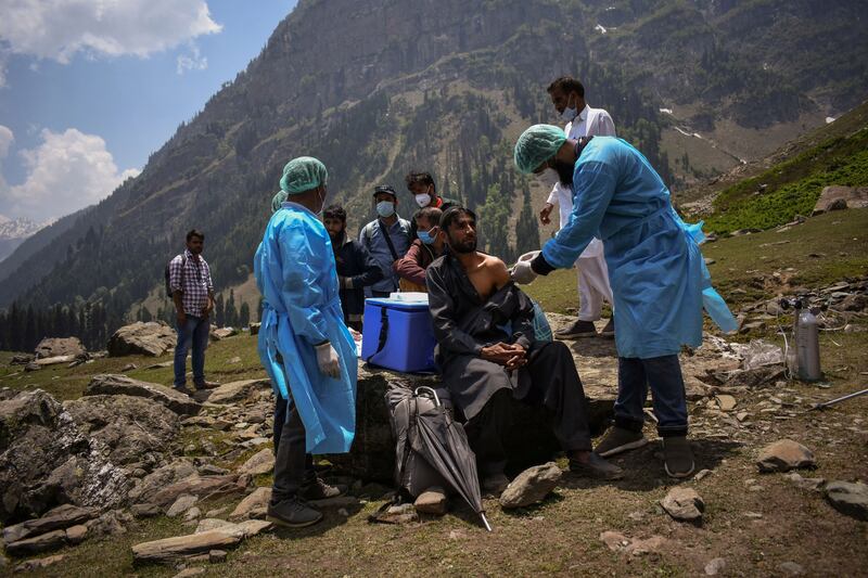 A healthcare worker administers a dose of CoviShield, a coronavirus disease vaccine, to a shepherd during a vaccination drive in Lidderwat, in India Kashmir's Anantnag district, on June 10, 2021.  By Sanna Irshad Mattoo,Pulitzer Prize Winner for Feature Photography. Reuters