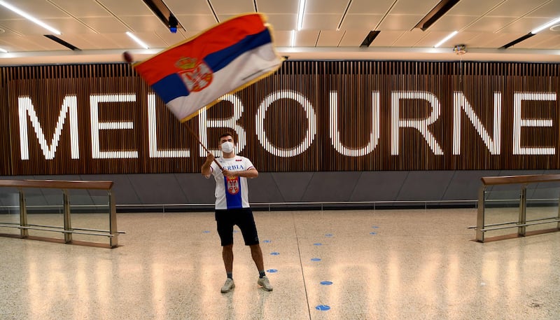 A Serbian tennis fan waves the country's flag as he awaits the arrival of Serbia's tennis champion Novak Djokovic in Melbourne Australia. However, world number one  Djokovic faces being deported and missing the Australian Open, as his visa was revoked amid a backlash over Covid-19 vaccine exemption. AFP