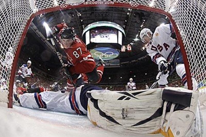 Canada's Sidney Crosby, left, is thwarted by the US goaltender Ryan Miller during their preliminary round match.
