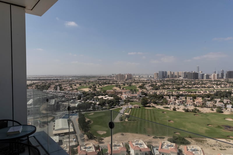 The flat has views over the Els Club golf course and Dubai Marina is in the distance

