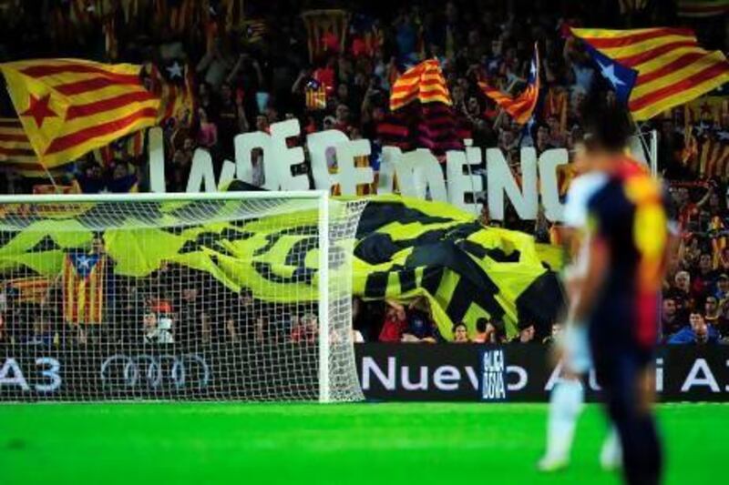 Barcelona's football fans hold letters forming the word "Independencia" and wave "Estelada", the Catalan independentist flag, during the match against Real Madrid in October.