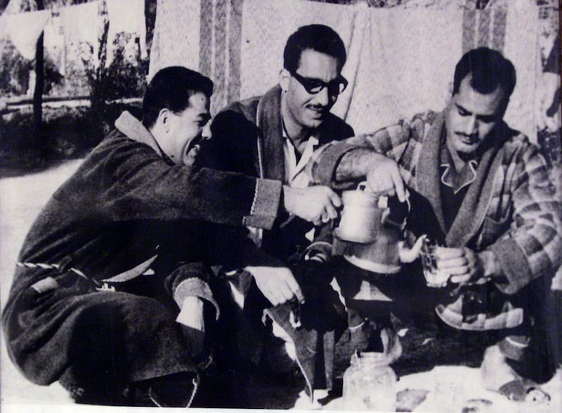 Saddam Hussein, left, in his housecoat, is seen preparing a hot drink with unidentified others in this photo taken in the 1960s, as his influence in the Ba'ath Party was growing. AFP