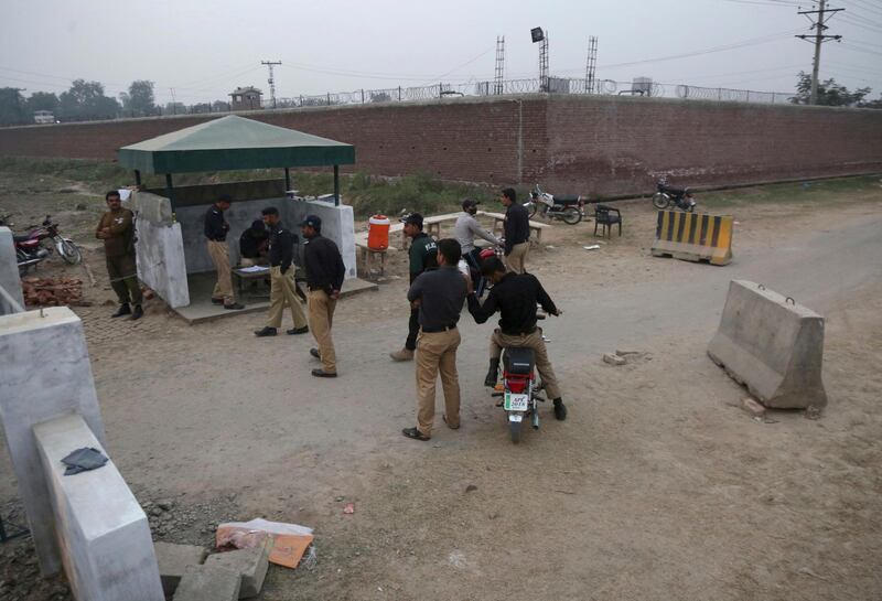 Pakistani police officers stand guard at a checkpoint of a prison where authorities executed Mohammad Imran convicted of killing eight children, in Lahore, Pakistan, Wednesday, Oct. 17, 2018. Mohammad Imran, a serial killer of eight children, was executed at the prison Wednesday morning after the country's top court rejected a request for his public hanging, officials said. (AP Photo/K.M. Chaudary)