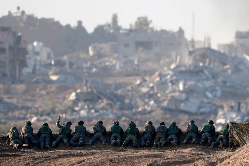 Israeli army soldiers keep position on a hill overlooking northern Gaza, amid continuing battles between Israel and Hamas. AFP