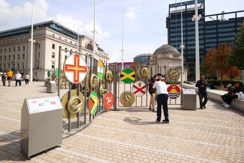 Members of the public pose with flags of the Commonwealth in Birmingham. Getty Images