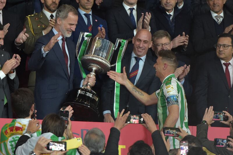 Real Betis captain Joaquin receives the trophy from King Felipe VI of Spain. AFP