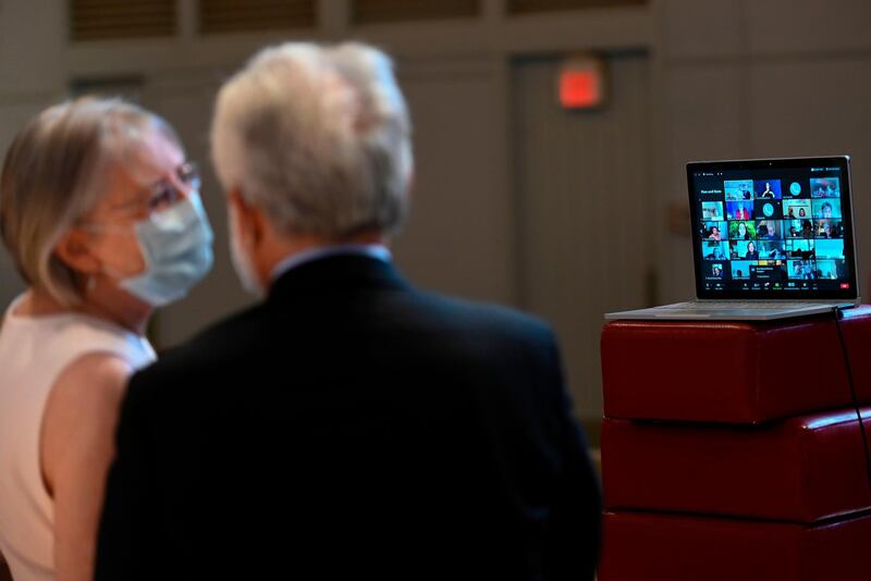 Linda Hoveskeland, right, and Ardell Hoveskeland speak with family and friends joining over Zoom after their socially distanced wedding at the Peace Lutheran Church in Alexandria, Virginia, USA. AFP