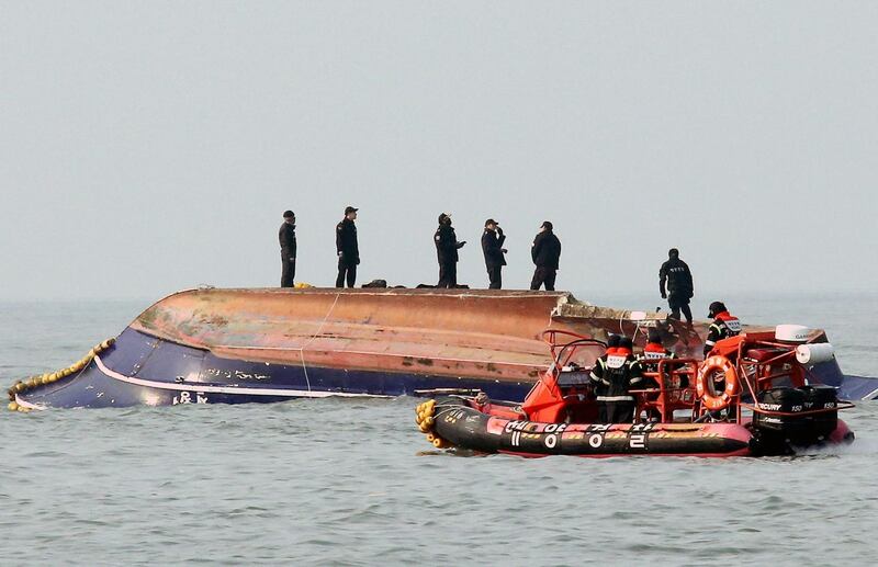 South Korean coastguard members search for missing persons after a fishing boat crashed with a fuel tanker at sea near the western port city of Incheon on December 3, 2017.
Thirteen people were killed and two were missing after a fishing boat collided with a tanker off South Korea's west coast and capsized early on December 3, the country's coastguard said. 

 / AFP PHOTO / YONHAP / - /  - South Korea OUT / NO ARCHIVES -  RESTRICTED TO SUBSCRIPTION USE