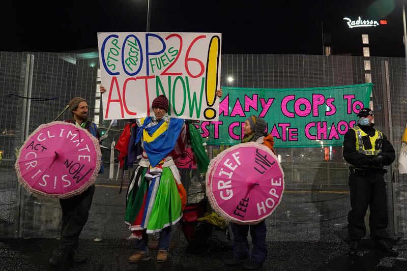 Climate activists stage a protest outside the Cop26 venue where negotiations continued well past the initial deadline. PA