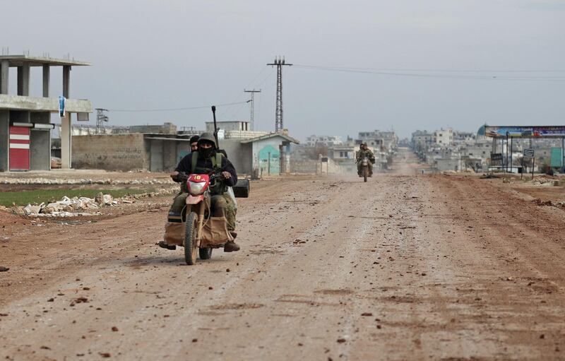 Syrian rebel fighters ride motorcycles amid clashes with government forces in Syria's northern Idlib countryside.   AFP