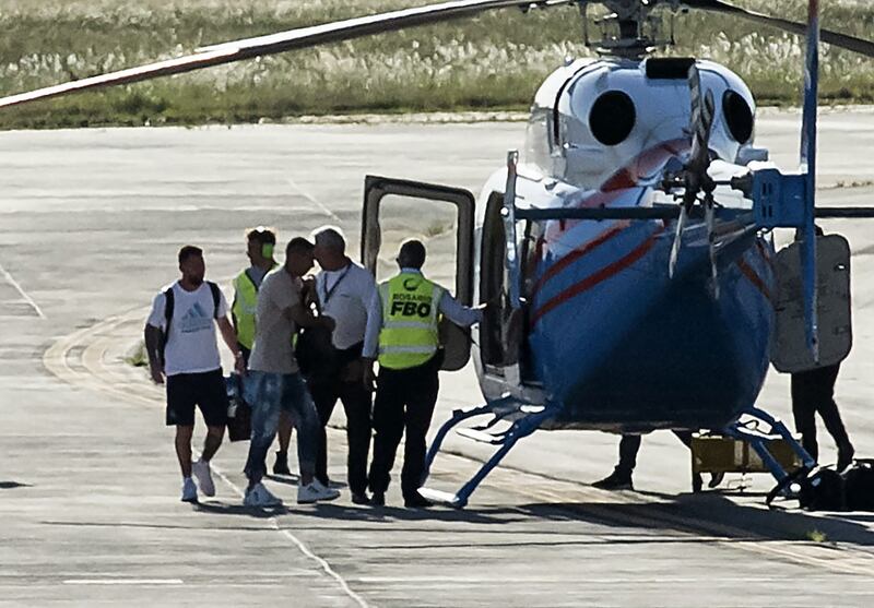 Argentina's Lionel Messi Angel Di Maria prepare to board a helicopter. AFP
