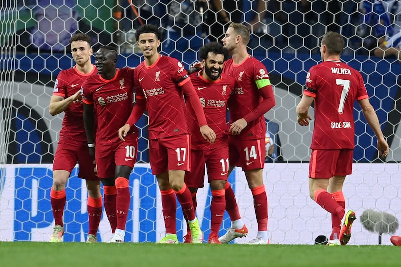 Mohamed Salah of Liverpool celebrates with teammates Jordan Henderson, Curtis Jones and Sadio Mane after scoring the first goal in their Champions League routing of Porto at Estadio do Dragao on Tuesday in Portugal. Getty