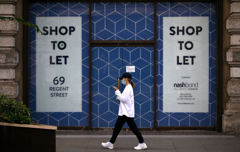 A pedestrian passes a shop to let in London. Global GDP growth is expected to slow to 0.5 per cent in the fourth quarter of the year, according to the IIF. AFP