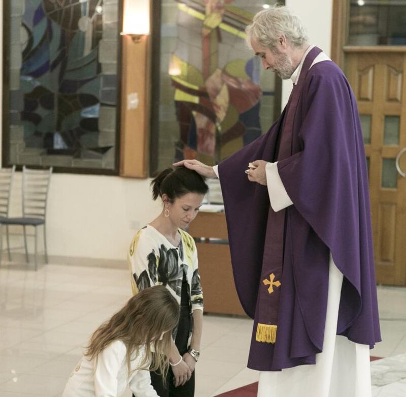 The Reverend Canon Stephen Wright, pictured during holy communion at Christ Church, Jebel Ali, will be leaving his congregation after 11 years of service. Reem Mohammed / The National