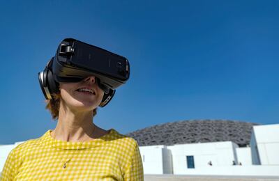 Abu Dhabi, United Arab Emirates - February 15th 2018: Reporter Melissa Gronlund trying on the VR headset at a press conference about the Highway Gallery located along the E11. Thursday, February 15th, 2018. The Louvre, Abu Dhabi. Chris Whiteoak / The National