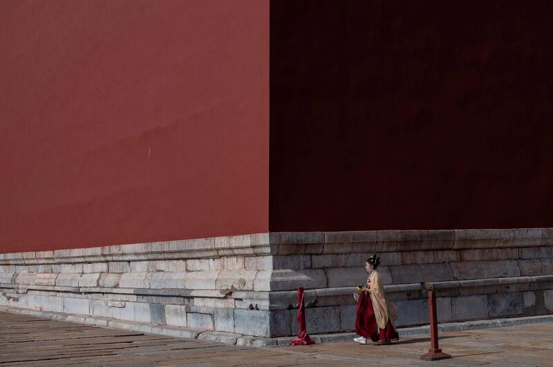 A woman walks towards the main entrance of the Forbidden City in Beijing, China. AFP
