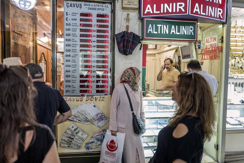 Shoppers wait outside a currency exchange in the Grand Bazaar in Istanbul, Turkey, on Friday, Aug. 17, 2018. Turkish President Recep Tayyip Erdogan argued citizens should buy gold, then he said sell. Add dramatic swings in the lira, and the country’s traders are now enthusiastically doing both. Photographer: Ismail Ferdous/Bloomberg
