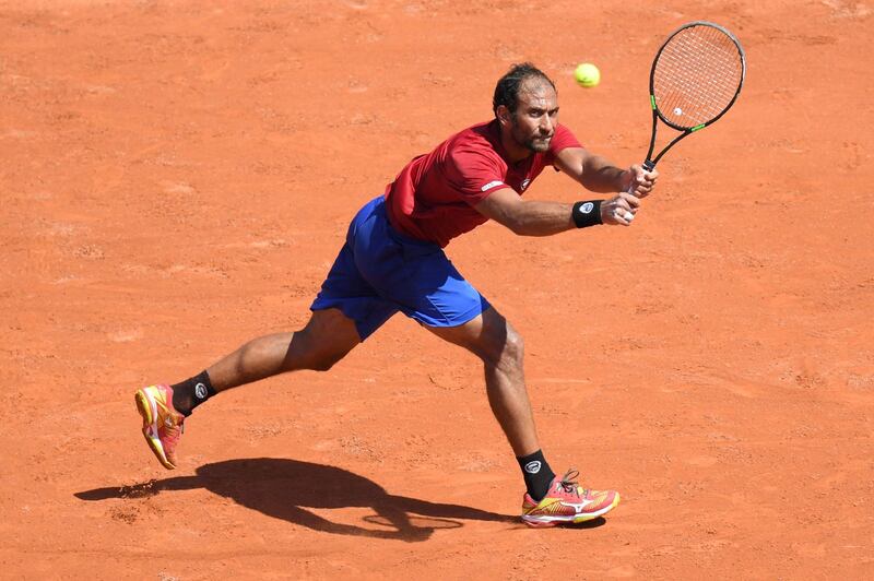 Egypt's Mohamed Safwat plays a return to Bulgaria's Grigor Dimitrov during their men's singles first round match on day one of The Roland Garros 2018 French Open tennis tournament in Paris on May 27, 2018. (Photo by CHRISTOPHE ARCHAMBAULT / AFP)        (Photo credit should read CHRISTOPHE ARCHAMBAULT/AFP/Getty Images)