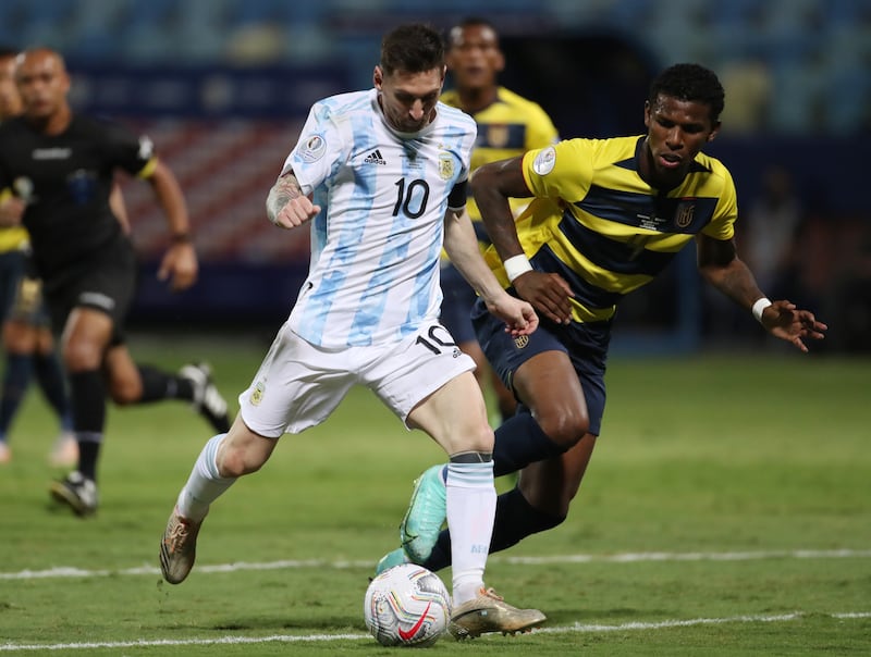 Lionel Messi in action with Ecuador's Robert Arboleda.