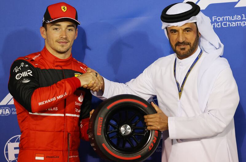 Ferrari's Monegasque driver Charles Leclerc (L) receives the Pole Position Award  from the President of the International Automobile Federation (FIA) Mohammed ben Sulayem after the qualifying session on the eve of the Bahrain Formula One Grand Prix at the Bahrain International Circuit in the city of Sakhir on March 19, 2022.  (Photo by Giuseppe CACACE  /  POOL  /  AFP)