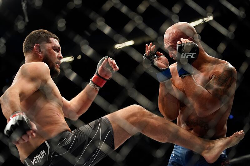 Nick Diaz, left, throws a kick against Robbie Lawler. AP Photo