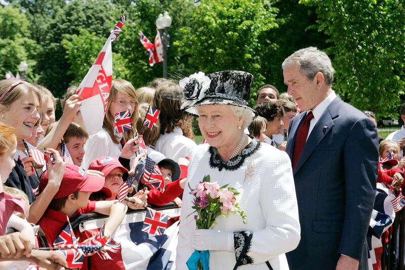 The queen and former US president George W Bush meet well-wishers outside the White House in May 2007. Getty Images