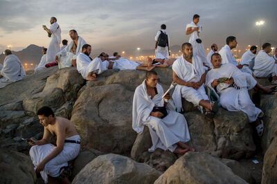 Muslim pilgrims pray on the Jabal Al Rahma holy mountain, or the mountain of forgiveness, at Arafat for the annual hajj pilgrimage outside the holy city of Mecca, Saudi Arabia, Monday, Aug. 20, 2018. More than 2 million Muslims have begun the annual hajj pilgrimage. The five-day pilgrimage represents one of the five pillars of Islam and is required of all able-bodied Muslims once in their life. (AP Photo/Dar Yasin)