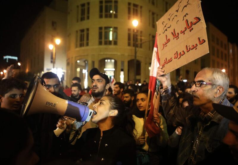 Lebanese anti-corruption protesters shout slogans outside the parliament to denounce the nomination of Prime Minister-designate Hassan Diab. AFP