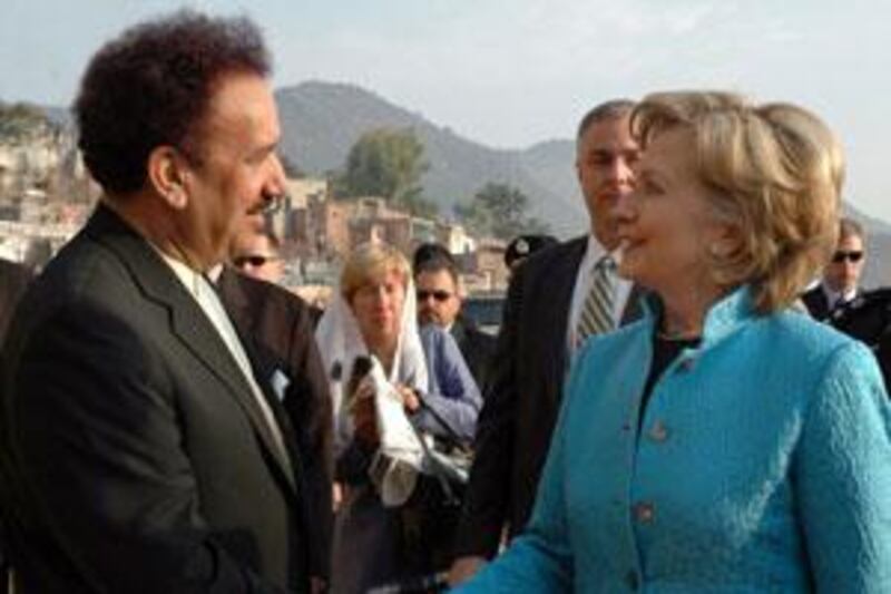 US Secretary of State Hillary Clinton, right, shakes hands with the Pakistani interior minister Rehman Malik, left, during a visit to Islamabad on October 29, 2009.