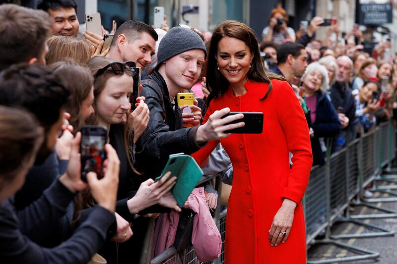 Catherine, Princess of Wales, smiles as a well-wisher takes a picture during her visit to central London to see coronation preparations. Reuters