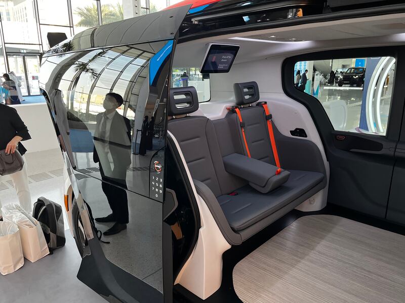 Inside a Cruise driverless taxi. Seats face each other and the vehicles can seat up to six people, with ample room for luggage.