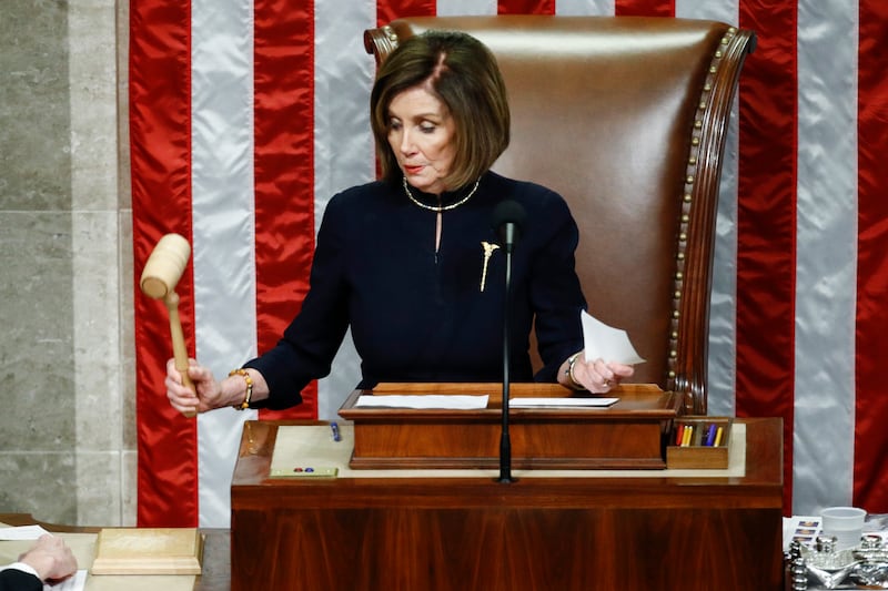 Ms Pelosi announcing the passage of Article II of impeachment against Mr Trump in December 2019. AP