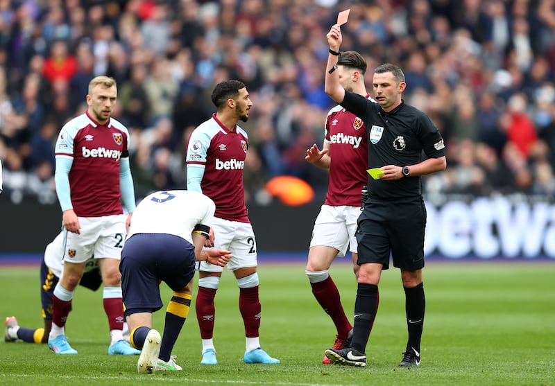 Michael Oliver shows a red card to Everton's Michael Keane. Getty