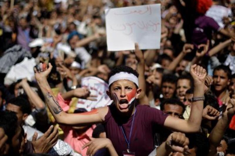 An young anti-government protestor, center, shouts slogans during a demonstration demanding the resignation of Yemeni President Ali Abdullah Saleh, in Sanaa, Yemen, Friday, Feb. 25, 2011. Tens of thousands of people gathered in a main square in the Yemeni capital for Friday prayers that later turned into mass protests to press demands for the U.S.-backed president to step down. Banner reads in Arabic, " Silence is death without dying". (AP Photo/Muhammed Muheisen) *** Local Caption ***  XMM102_Mideast_Yemen.jpg