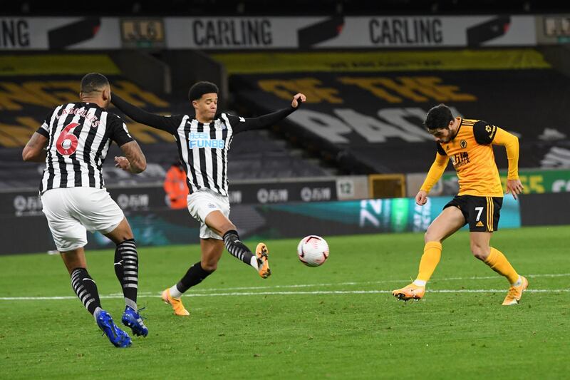 Wolverhampton Wanderers' Pedro Neto, right. attempts a shot at goal in front of Newcastle's Jamal Lewis, center, and Jamaal Lascelles at the Molineux Stadium on Sunday. AP