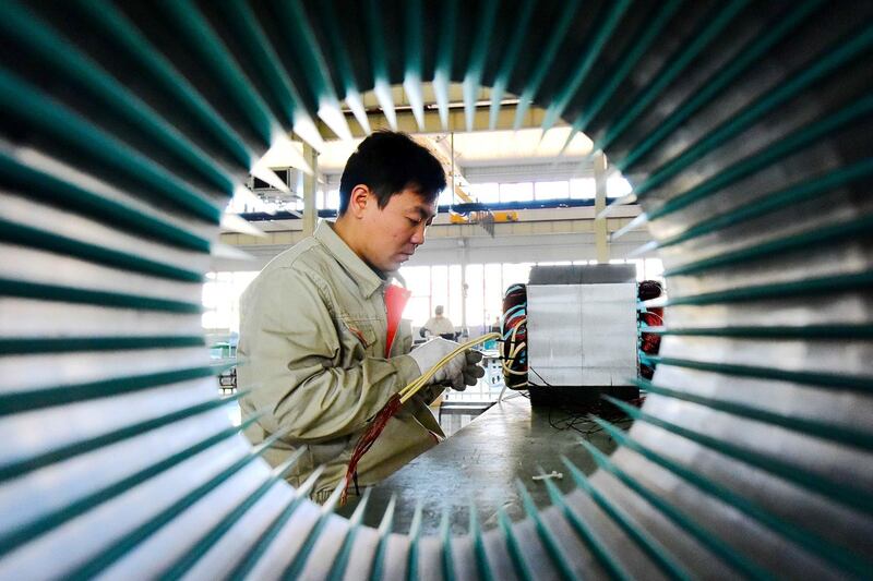 A man works on electric machine parts at a workshop of an equipment manufacturing company in Weifang, Shandong province, China October 31, 2018. China Daily via REUTERS  ATTENTION EDITORS - THIS IMAGE WAS PROVIDED BY A THIRD PARTY. CHINA OUT.