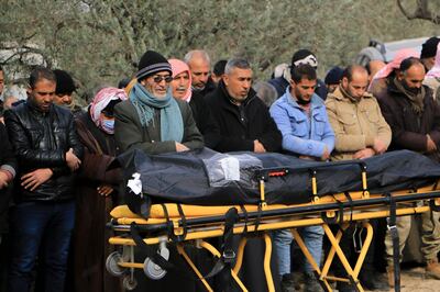 Friends and family gather to offer prayers for a loved one at Salqeen cemetery in north-west Syria. Abd Almajed Alkarh / The National