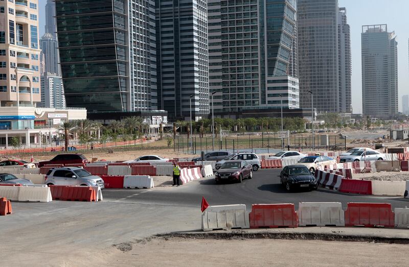 Dubai, United Arab Emirates - September 10, 2013.  Traffic building up as early as 8:30 am in this small temporary roundabout at the back of the JLT towers but slowly improving due to securities or traffic enforcers around the area, road construction in JLT is still ongoing.   ( Jeffrey E Biteng / The National )  Editor's Note;  Caline M reports. *** Local Caption ***  JB100913-Traffic07.jpg